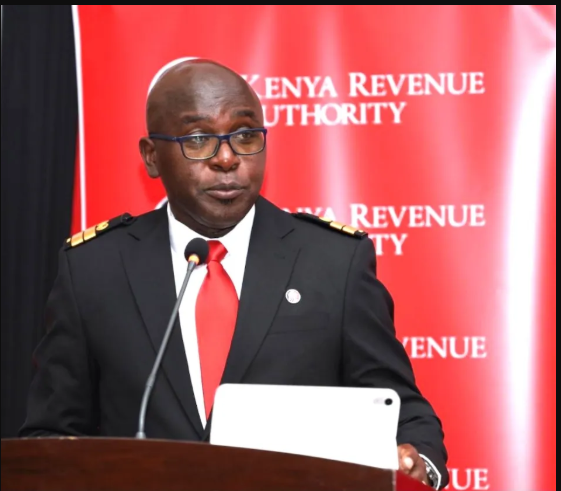 Humphrey Wattanga, KRA Commissioner General, wearing a suit and speaking at an official event on tax reforms.