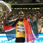 Emmanuel Wanyonyi crosses the finish line with his arms raised in victory after winning the 800m race.