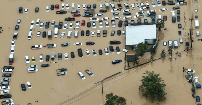 A drone view captures dozens of vehicles submerged in a flooded car park in Hat Yai.